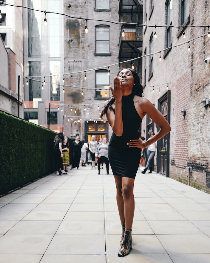 A model rehearses poses on a rooftop terrace in New York City