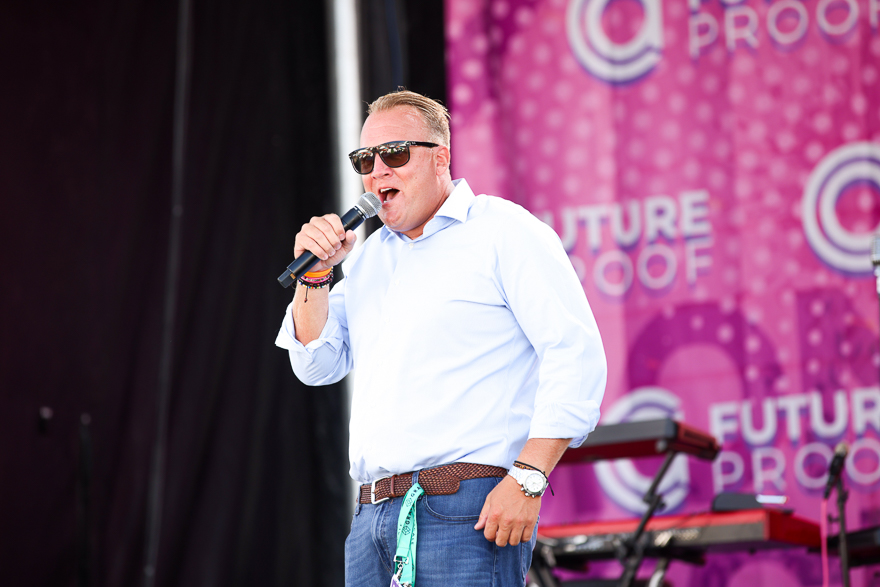 A host at FutureProof welcomes guests