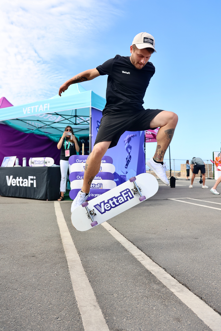 Brian Pfaff does a kickflip on a branded skateboard at Future Proof
