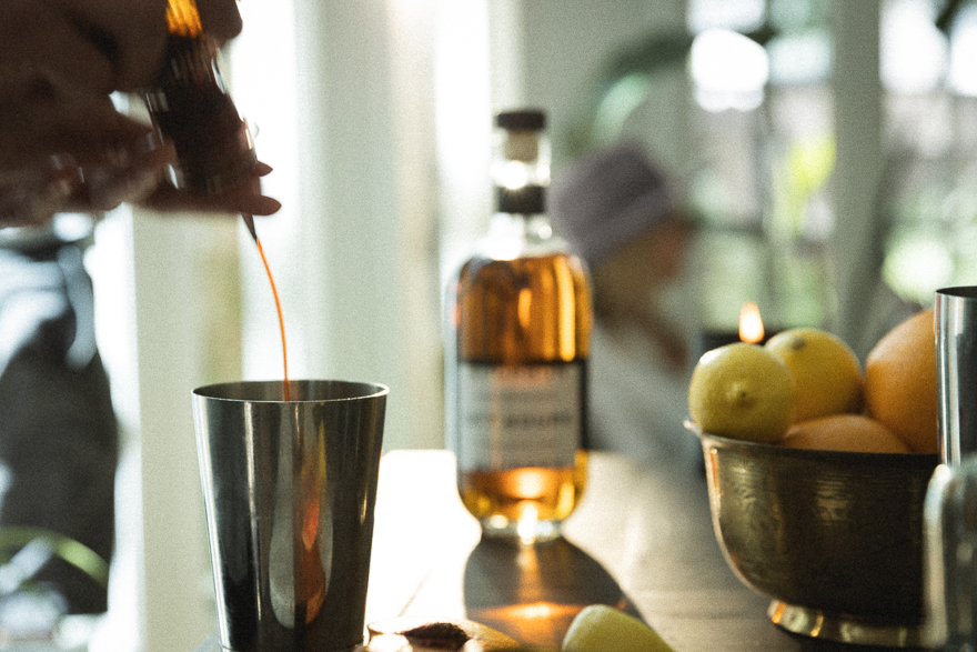 Hands mixing cocktails