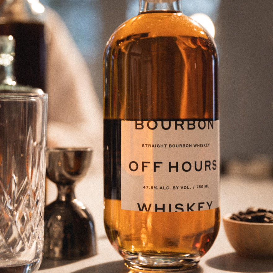 A bottle of Off Hours Whiskey on the counter with cocktail ingredients