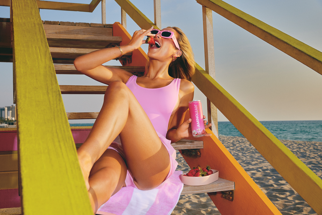 Alix Earle with Aminolean Berry Alixer on South Beach Miami's lifeguard towers