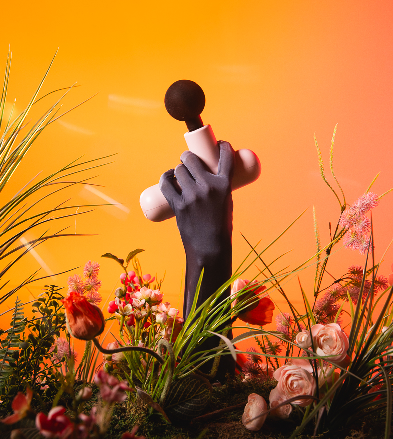 A hand holding the Lola massager