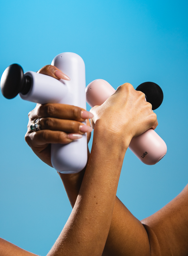 A hand holding the Lola massager