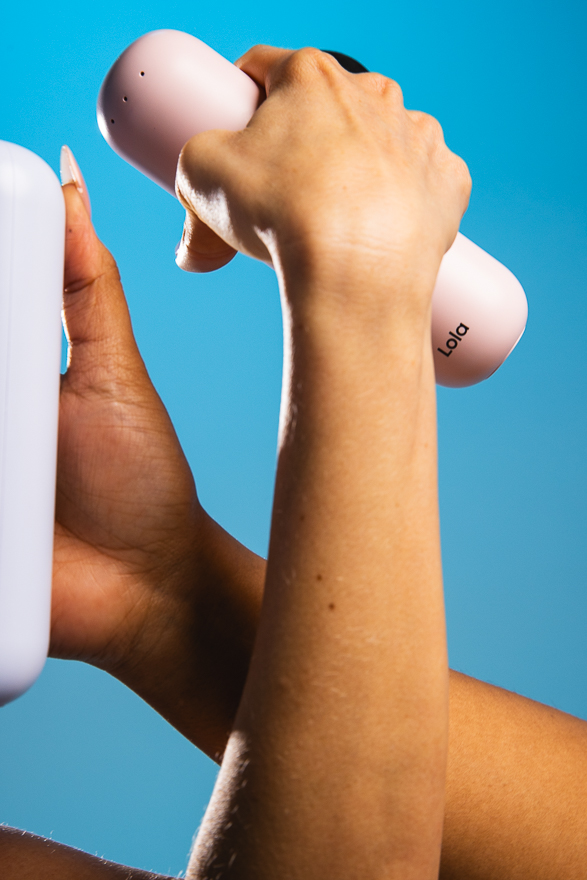 A hand holding the Lola massager