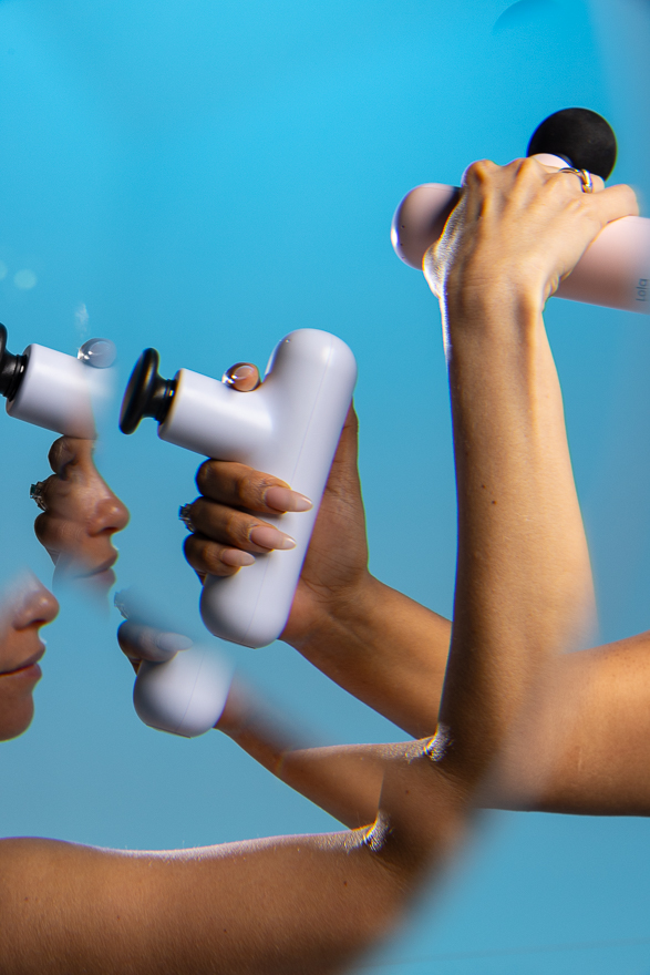 A hand holding the Lola massager