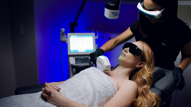 A woman receiving a BBL Heroic treatment with a Sciton device