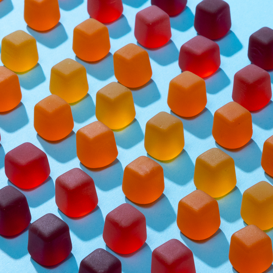 Catface juiceblox gummies arranged on a table in a geometric pattern