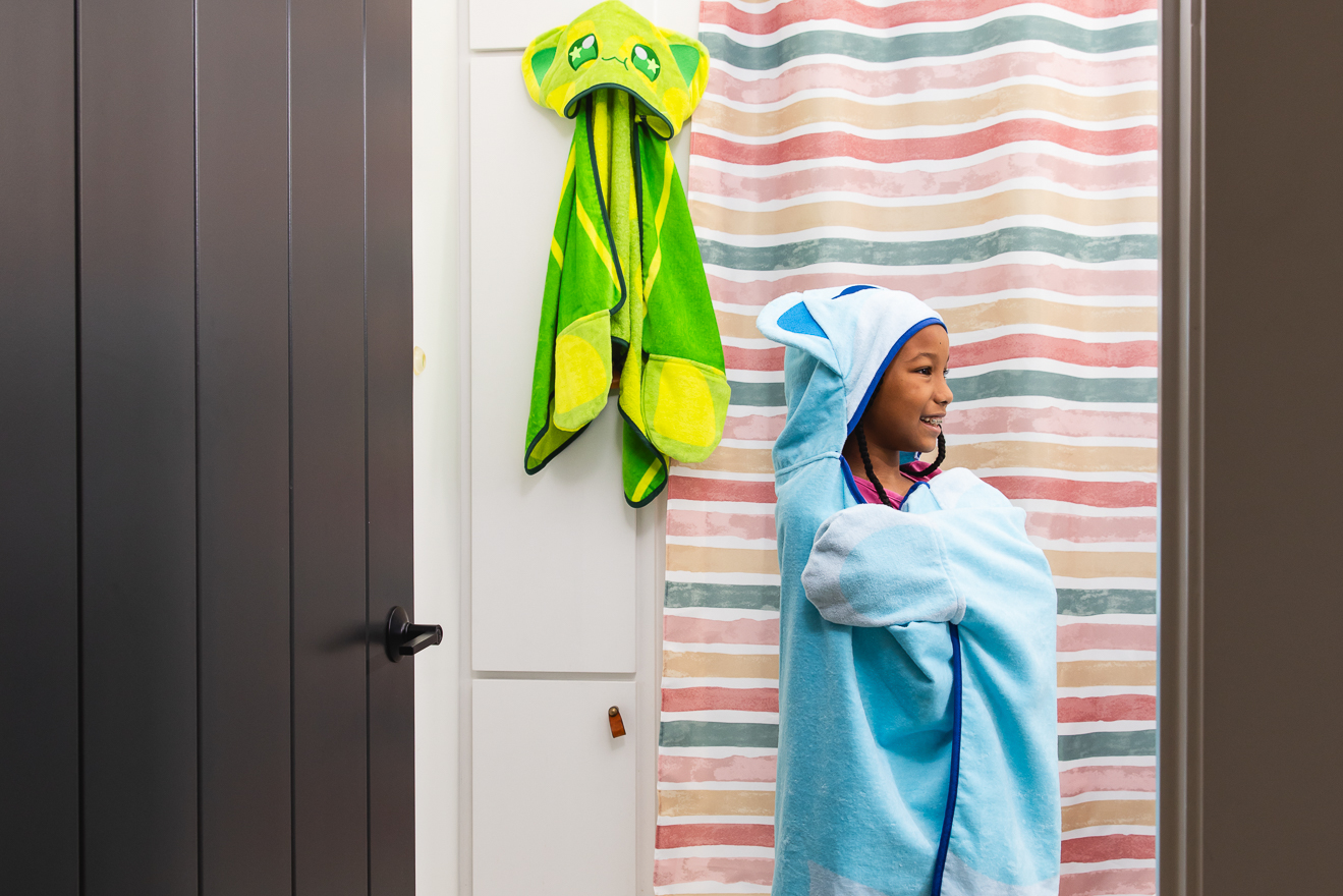 A kid with Catface hooded towels