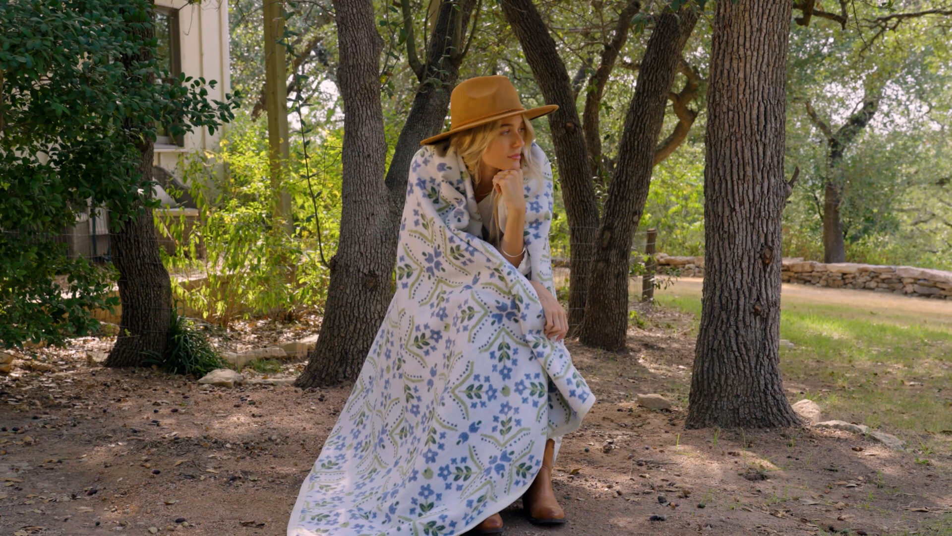 A woman in a field with a Chappywrap blanket