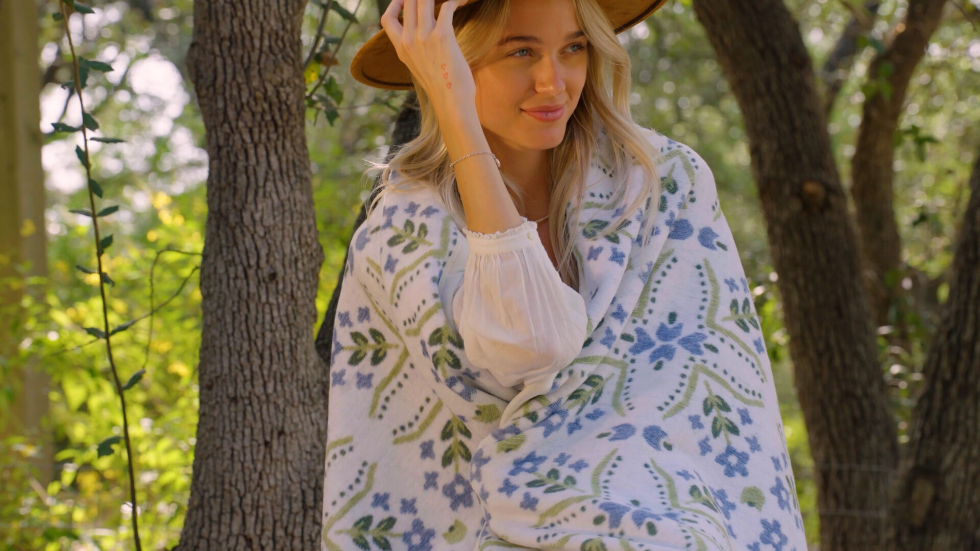 A woman outside with a Chappywrap blanket