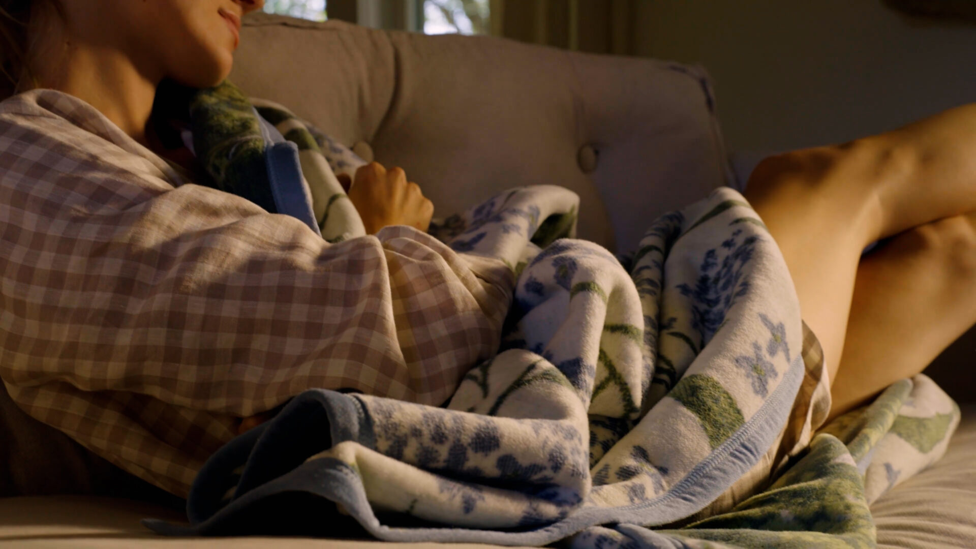 A woman in a chic hotel room with a Chappywrap blanket