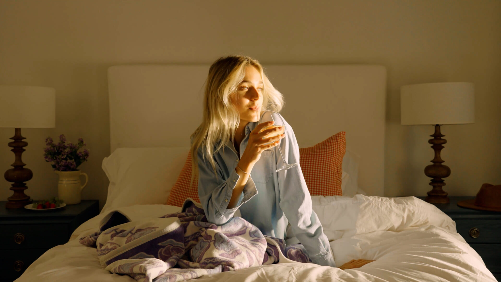 A woman in a hotel room with a Chappywrap blanket