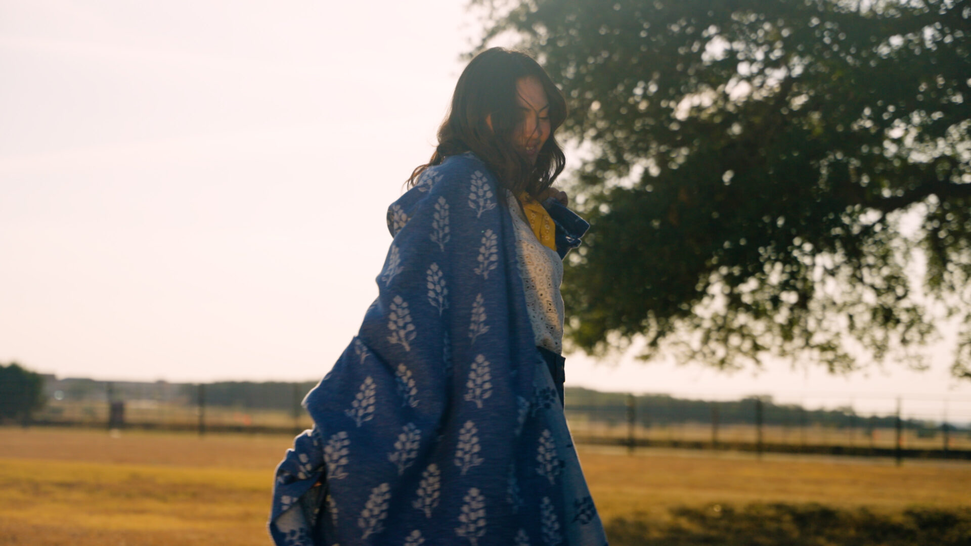 A woman walking outside with a Chappywrap blanket