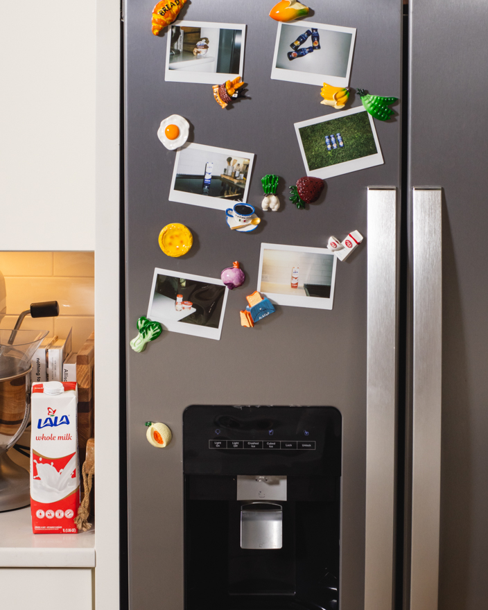 A refrigerator in a kitchen with Lala milk on the counter