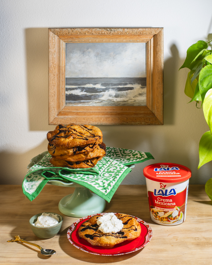 Bunuelos on the counter with Lala crema Mexicana