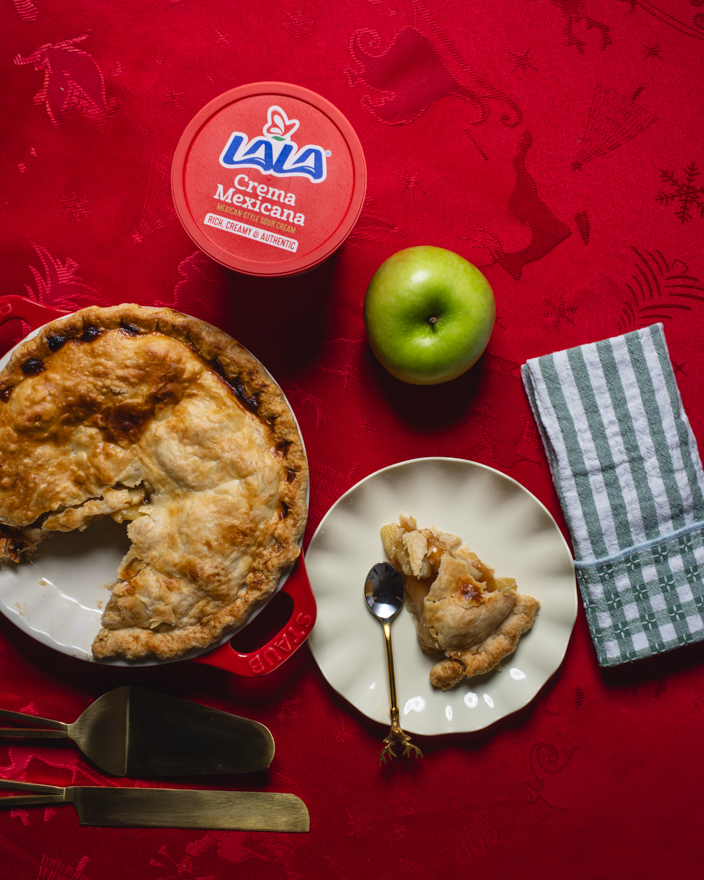 Apple pie on the table with Lala crema Mexicana