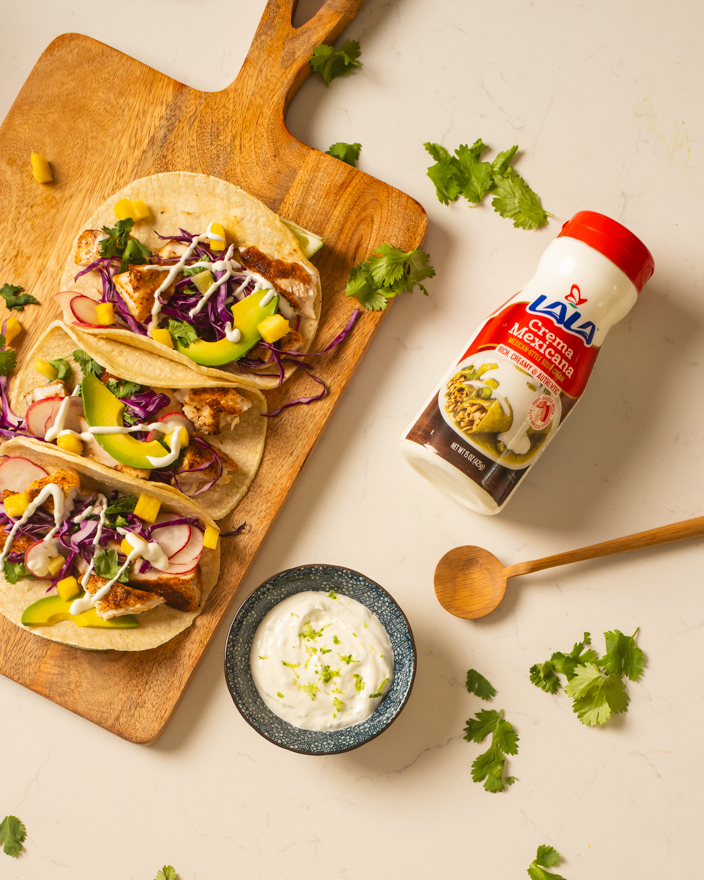 Authentic street tacos featuring Lala crema Mexicana