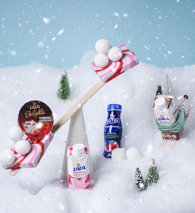 A styled still-life photograph with Lala products skiing down a hill