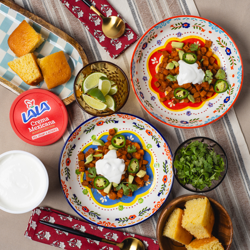 A table spread of Mexican food with Lala crema Mexicana