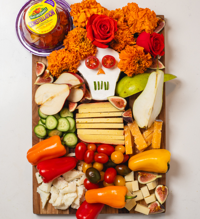A charcuterie board featuring nature sweet tomatoes
