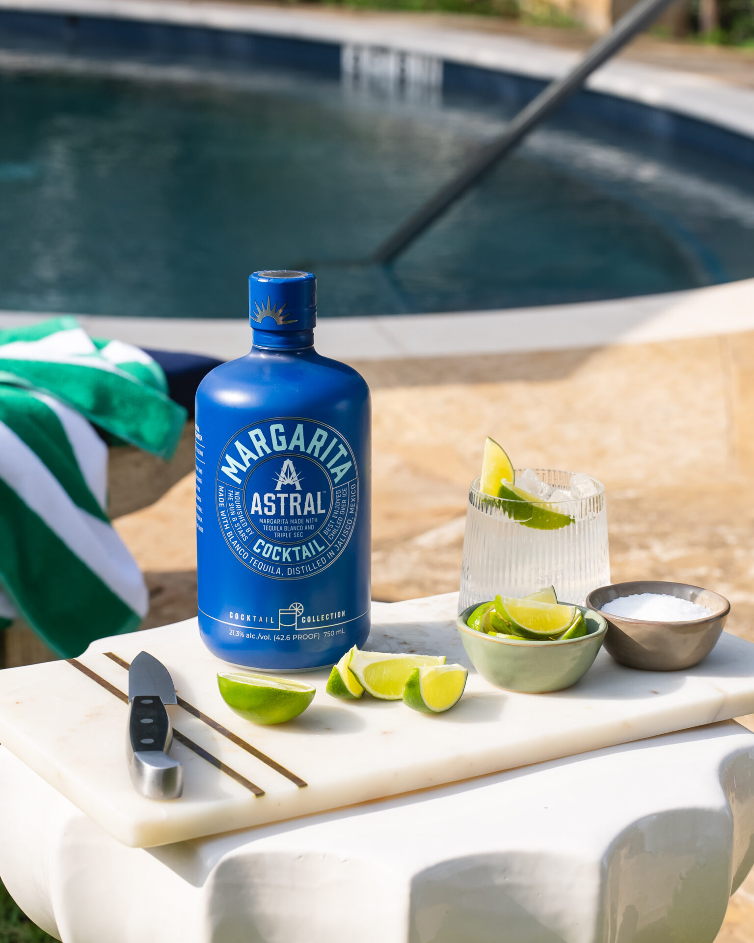 The Cocktail Collection Astral margarita by a pool with glassware