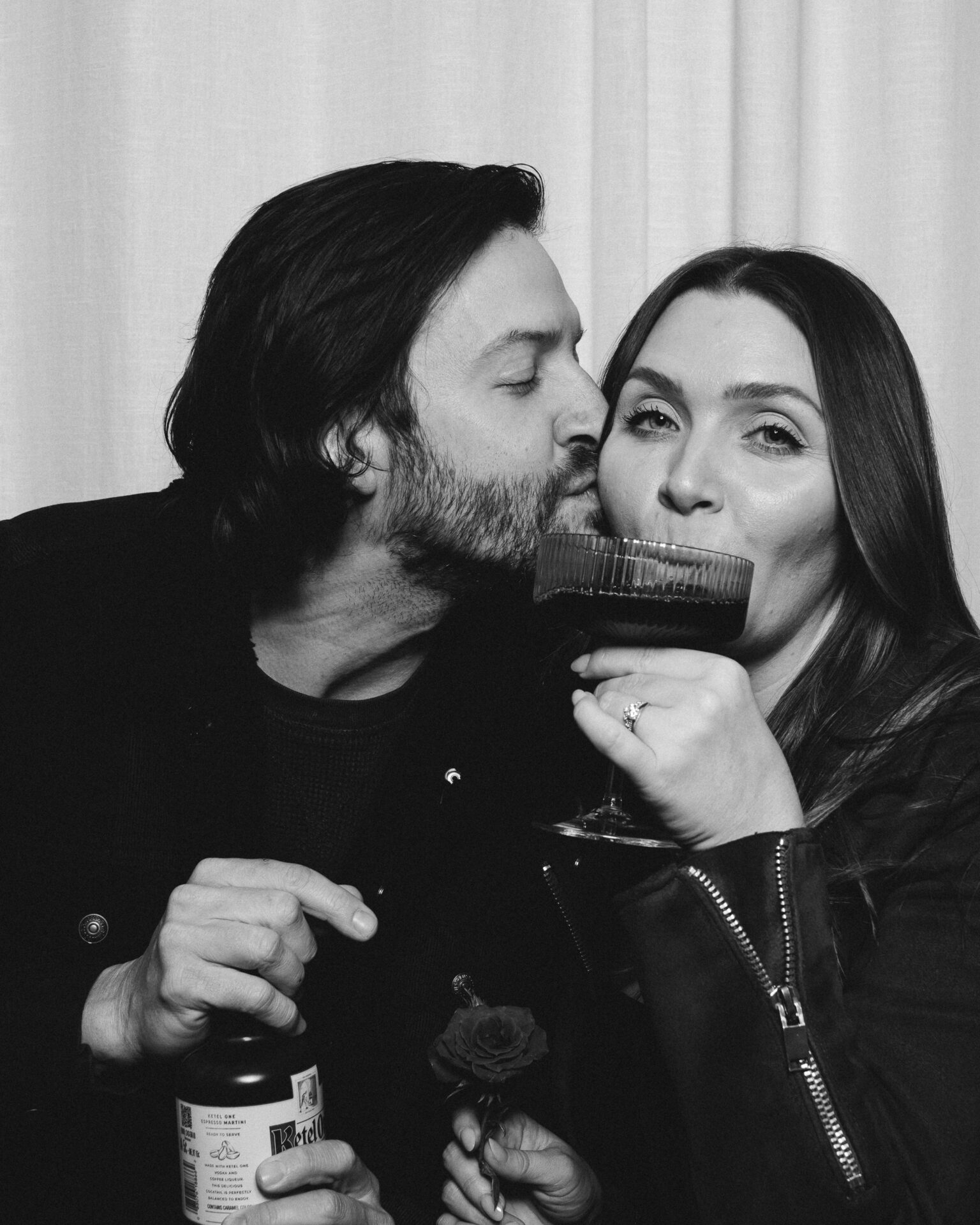 A couple in a photobooth with espresso martinis
