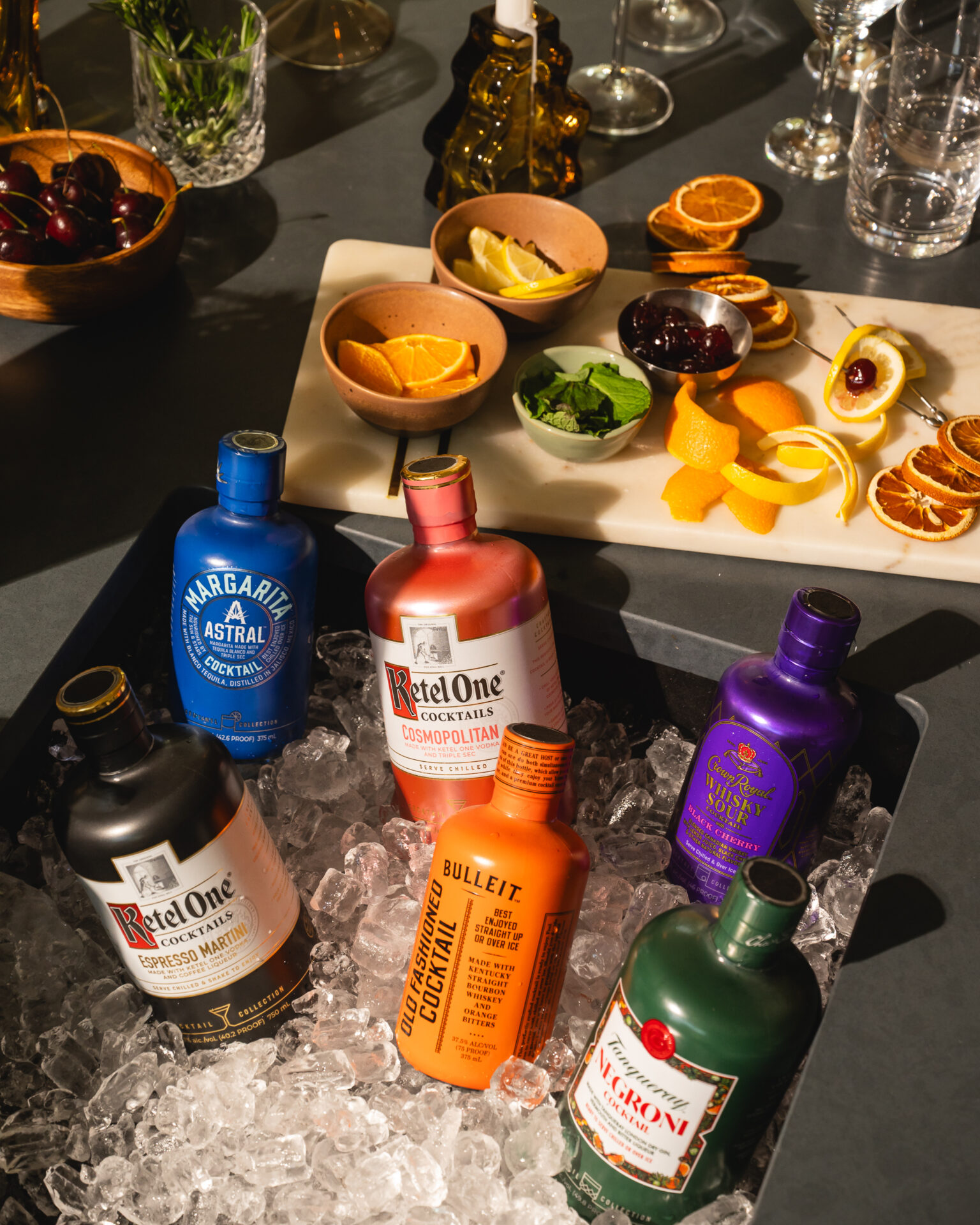 The Cocktail Collection bottles in a sink filled with ice