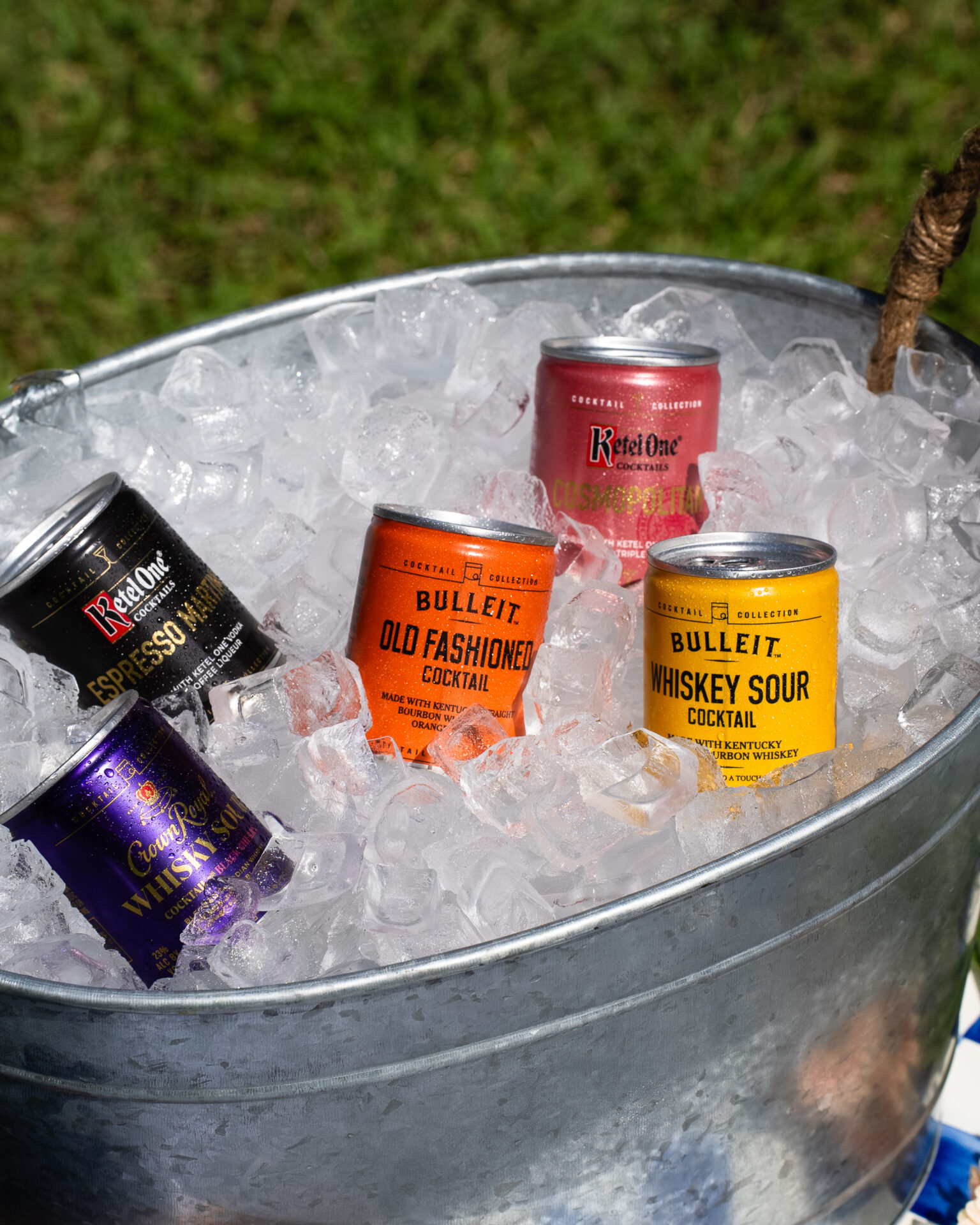 Small cans of The Cocktail Collection chilling on ice