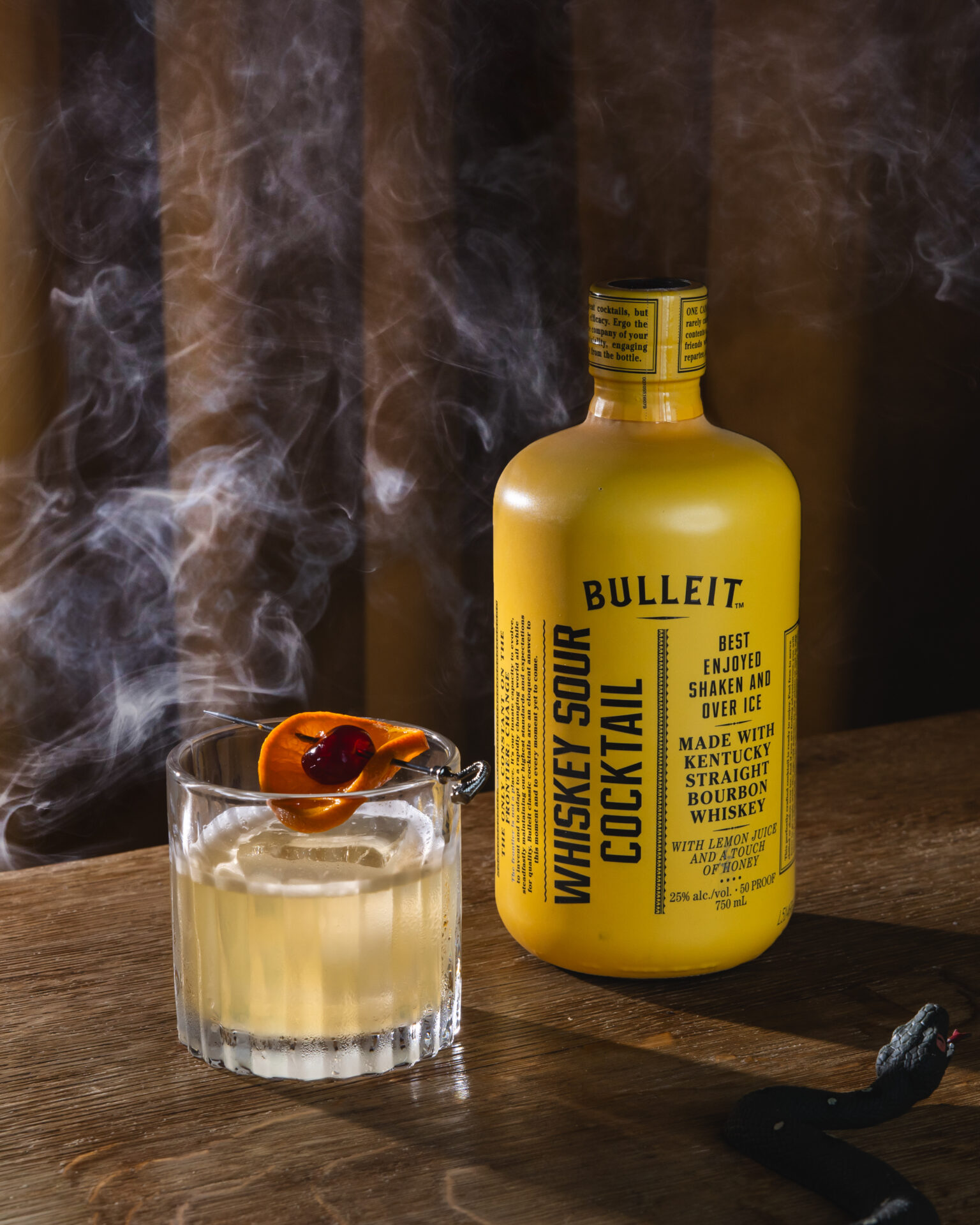 A spooky Halloween-themed still-life featuring The Cocktail Collection Bulleit whiskey sour