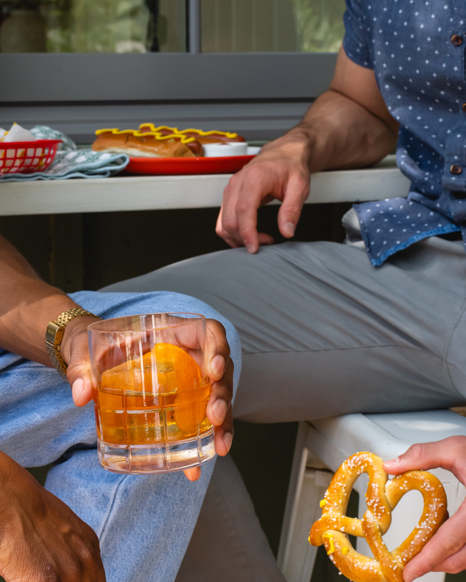 Men enjoying The Cocktail Collection old fashioned on the porch