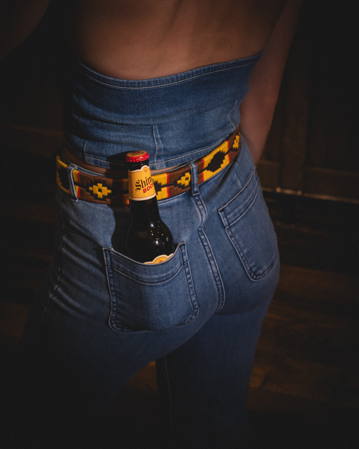 A beer in a girl's back pocket 