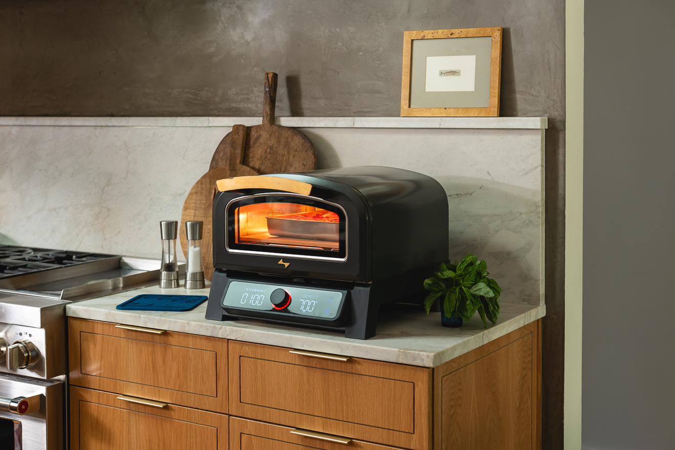 Lifestyle photography featuring the Current electric pizza oven P+